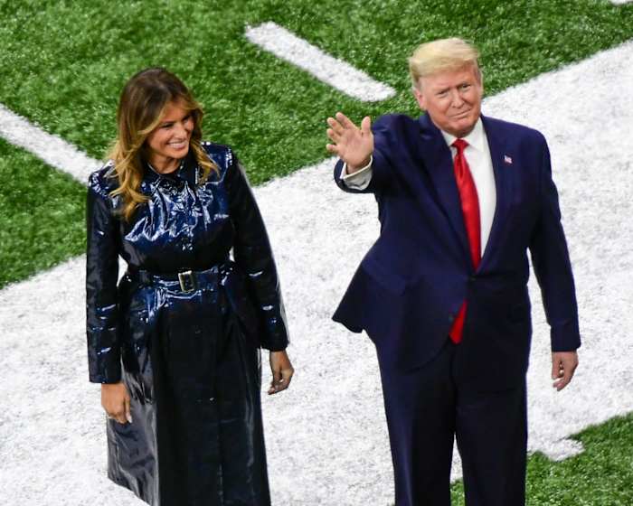 President Donald Trump stands with first lady Melania Trump on the field of the College Football Playoff final